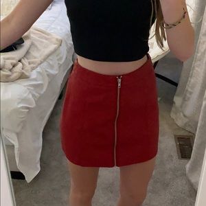 Red faux leather skirt with gold zipper.